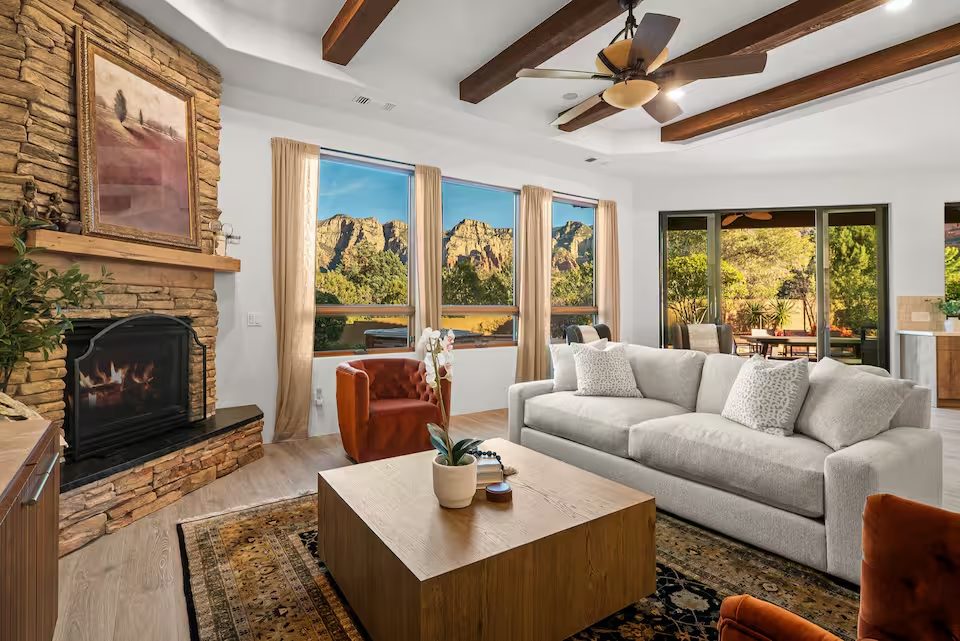Great room with wood-beam ceilings and red rock views